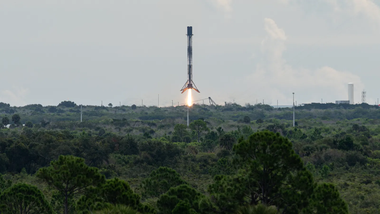 A Falcon 9 first stage descending on its engine flame to Landing Zone 40 at Cape Canaveral on October 1, 2026, after launching the Crew-13 mission