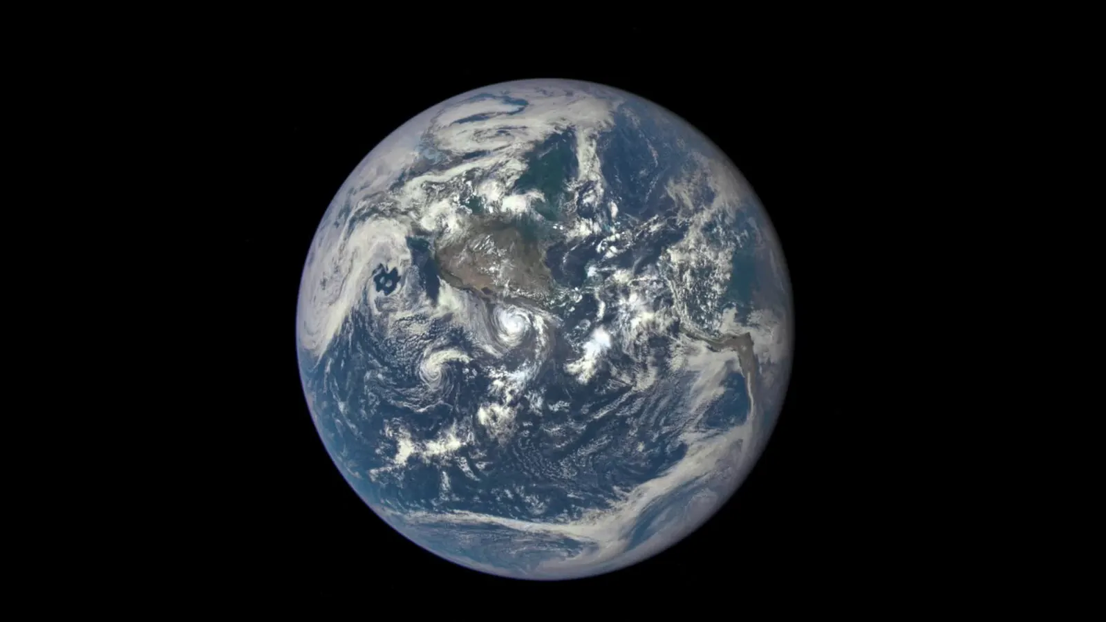 The full sunlit face of Earth over the Pacific Ocean and the Americas, with swirling storm clouds, photographed by NASA's EPIC camera on the DSCOVR spacecraft from about a million miles away near the Sun-Earth L1 point