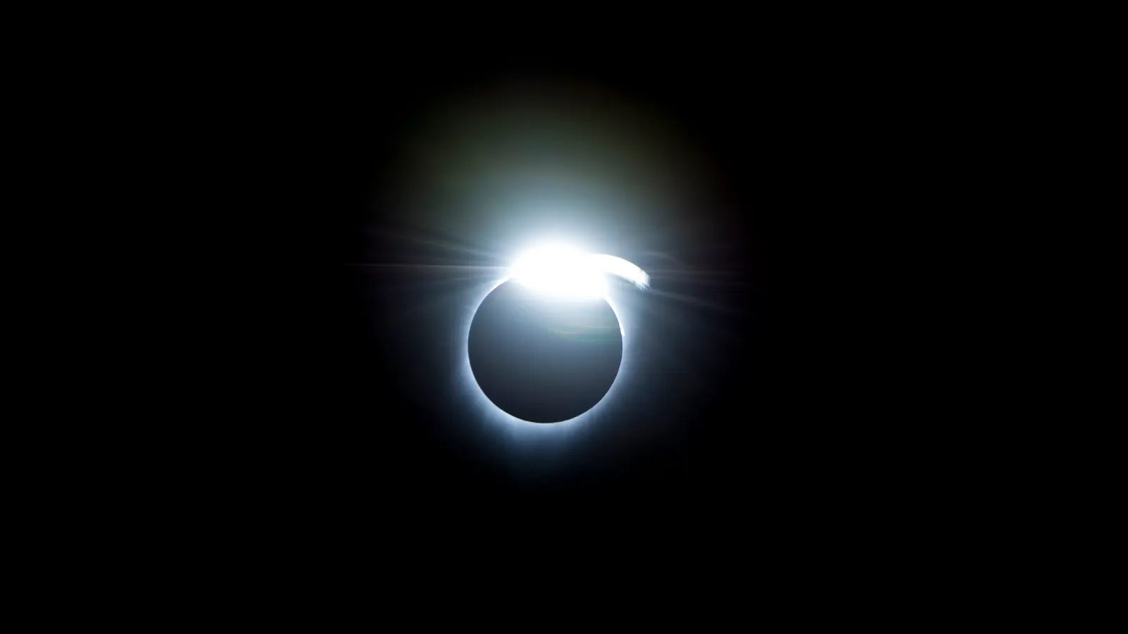 The diamond-ring effect during the total solar eclipse of August 21, 2017: one brilliant point of sunlight on the rim of the Moon's dark disk, inside the faint glow of the corona