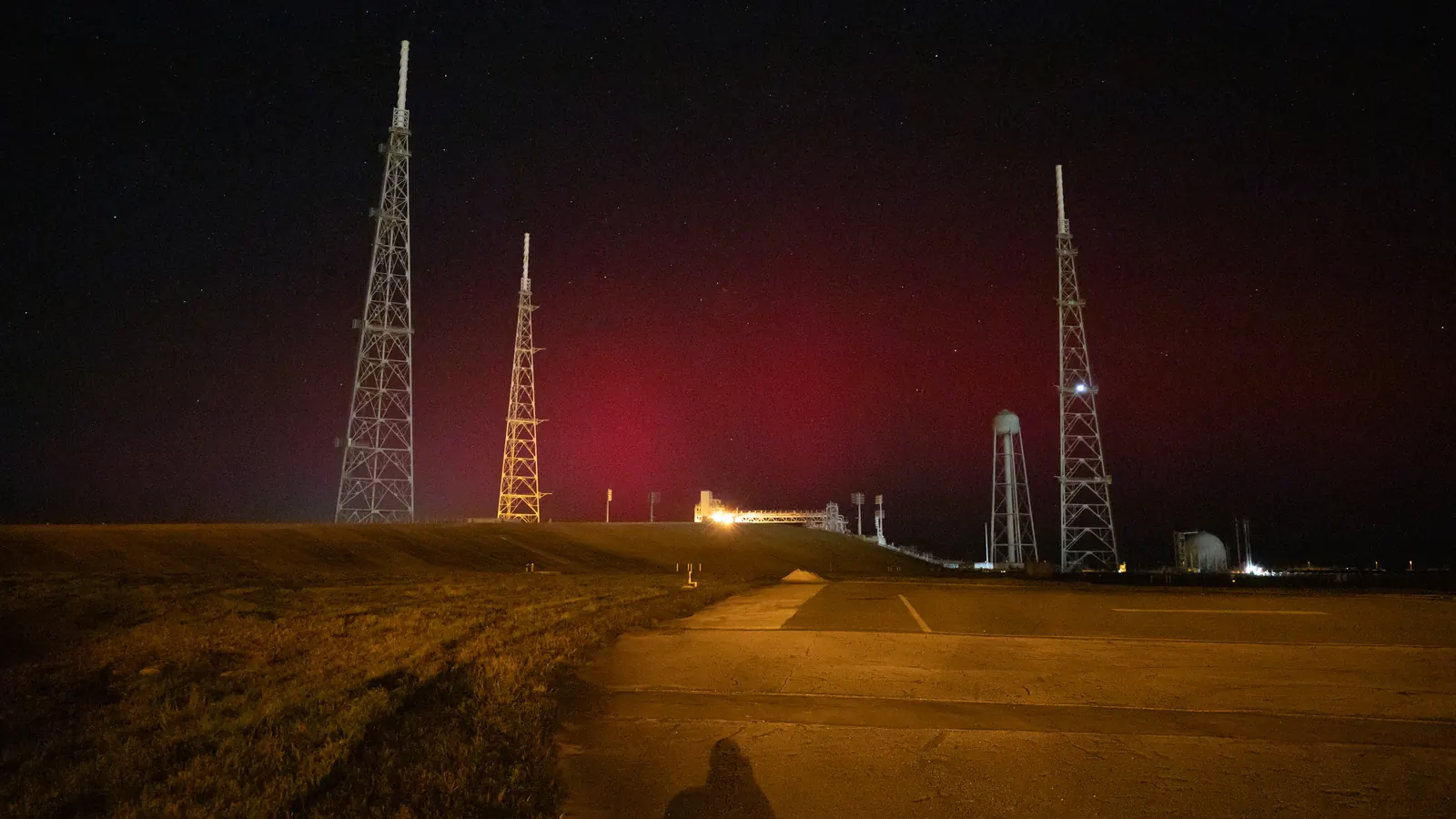 The faint red glow of an aurora over Launch Complex 39B at NASA's Kennedy Space Center in Florida on November 11, 2025